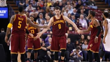 Jan 11, 2015; Sacramento, CA, USA; Cleveland Cavaliers forward Kevin Love (0) high fives guard J.R. Smith (5) and guard Kyrie Irving (2) after a play against the Sacramento Kings during the fourth quarter at Sleep Train Arena. The Sacramento Kings defeated the Cleveland Cavaliers 103-84. Mandatory Credit: Kelley L Cox-USA TODAY Sports