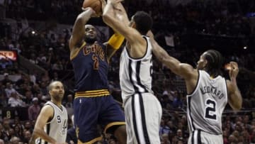 Mar 12, 2015; San Antonio, TX, USA; Cleveland Cavaliers forward LeBron James (23) shoots the ball over San Antonio Spurs power forward Tim Duncan (21) during the second half at AT&T Center. Mandatory Credit: Soobum Im-USA TODAY Sports