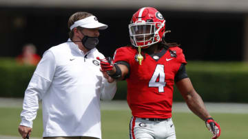ATHENS, GA - APRIL 17: Head coach Kirby Smart speaks with running back James Cook #4 of the Georgia Bulldogs during the first half of the G-Day spring game at Sanford Stadium on April 17, 2021 in Athens, Georgia. (Photo by Todd Kirkland/Getty Images)