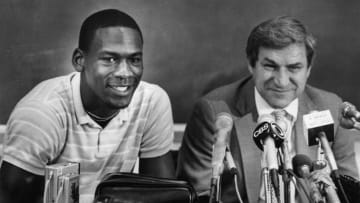 Michael Jordan is all smiles along with coach Dean Smith as Jordan announces at a 1984 press conference that he will forgo his senior year in college to play professional basketball. (Raleigh News & Observer/TNS via Getty Images)