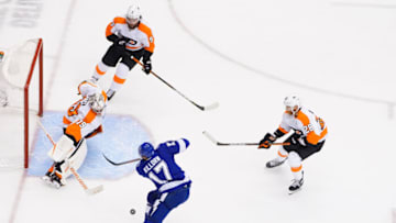 TORONTO, ONTARIO - AUGUST 08: Alex Killorn #17 of the Tampa Bay Lightning takes a shot on goal as Carter Hart #79 of the Philadelphia Flyers and Claude Giroux #28 of the Philadelphia Flyers defend during the first period in an Eastern Conference Round Robin game during the 2020 NHL Stanley Cup Playoff at Scotiabank Arena on August 08, 2020 in Toronto, Ontario, Canada. (Photo by Andre Ringuette/Freestyle Photo/Getty Images)