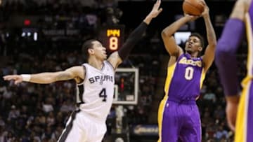 Apr 16, 2014; San Antonio, TX, USA; Los Angeles Lakers forward Nick Young (0) shoots the ball over San Antonio Spurs guard Danny Green (4) during the first half at AT&T Center. Mandatory Credit: Soobum Im-USA TODAY Sports