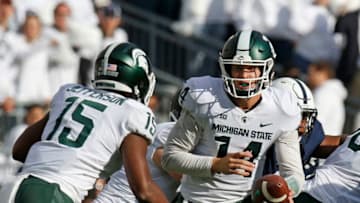 STATE COLLEGE, PA - OCTOBER 13: Brian Lewerke #14 of the Michigan State Spartans hands off to La'Darius Jefferson #15 of the Michigan State Spartans against the Penn State Nittany Lions on October 13, 2018 at Beaver Stadium in State College, Pennsylvania. (Photo by Justin K. Aller/Getty Images)