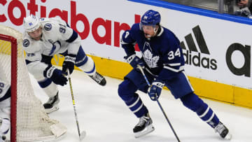 May 2, 2022; Toronto, Ontario, CAN; Toronto Maple Leafs forward Auston Matthews (34) moves the puck against Tampa Bay Lightning forward Steven Stamkos (91) during the second period of game one of the first round of the 2022 Stanley Cup Playoffs at Scotiabank Arena. Mandatory Credit: John E. Sokolowski-USA TODAY Sports