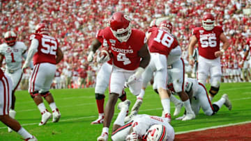 NORMAN, OK - SEPTEMBER 28: Running back Trey Sermon #4 of the Oklahoma Sooners jumps over linebacker Riko Jeffers #6 of the Texas Tech Red Raiders on his way to a touchdown at Gaylord Family Oklahoma Memorial Stadium on September 28, 2019 in Norman, Oklahoma. (Photo by Brett Deering/Getty Images)