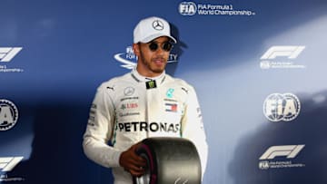 MELBOURNE, AUSTRALIA - MARCH 24: Lewis Hamilton of Great Britain and Mercedes GP is presented with the Pirelli Pole Position award in parc ferme after qualifying for the Australian Formula One Grand Prix at Albert Park on March 24, 2018 in Melbourne, Australia. (Photo by Charles Coates/Getty Images)