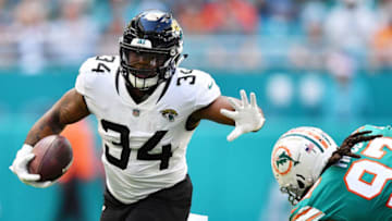 MIAMI, FLORIDA - DECEMBER 23: Carlos Hyde #34 of the Jacksonville Jaguars tries to avoid the tackle of Ziggy Hood #97 of the Miami Dolphins in the first quarter at Hard Rock Stadium on December 23, 2018 in Miami, Florida. (Photo by Mark Brown/Getty Images)