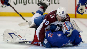 Dec 8, 2021; New York, New York, USA; Colorado Avalanche defenseman Samuel Girard (49) falls on top of New York Rangers goaltender Adam Huska (32) during the third period at Madison Square Garden. Mandatory Credit: Brad Penner-USA TODAY Sports
