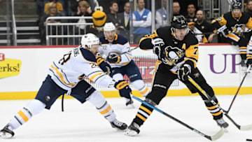 PITTSBURGH, PA - NOVEMBER 19: Evgeni Malkin #71 of the Pittsburgh Penguins handles the puck as Zemgus Girgensons #28 of the Buffalo Sabres defends during the second period in the game at PPG PAINTS Arena on November 19, 2018 in Pittsburgh, Pennsylvania. (Photo by Justin Berl/Getty Images)