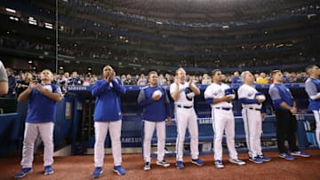 TORONTO, ON - APRIL 24: Manager John Gibbons #5 (L) of the Toronto Blue Jays and coaches stand as first responders are saluted the day after an attack that killed ten people during MLB game action against the Boston Red Sox at Rogers Centre on April 24, 2018 in Toronto, Canada. (Photo by Tom Szczerbowski/Getty Images)