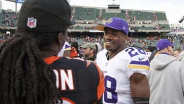 Dec 22, 2013; Cincinnati, OH, USA; Minnesota Vikings running back Adrian Peterson (28) talks with a Cincinnati Bengals player on the field post game at Paul Brown Stadium. Cincinnati Bengals beat the Minnesota Vikings by the score of 42-14. Mandatory Credit: Trevor Ruszkowksi-USA TODAY Sports