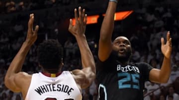May 1, 2016; Miami, FL, USA; Charlotte Hornets center Al Jefferson (25) shoots over Miami Heat center Hassan Whiteside (21) during the second half in game seven of the first round of the NBA Playoffs at American Airlines Arena. The Heat won 106-73. Mandatory Credit: Steve Mitchell-USA TODAY Sports