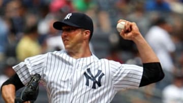 Jul 26, 2014; Bronx, NY, USA; New York Yankees starting pitcher Chris Capuano (26) delivers a pitch against the Toronto Blue Jays in the first inning at Yankee Stadium. Mandatory Credit: Noah K. Murray-USA TODAY Sports