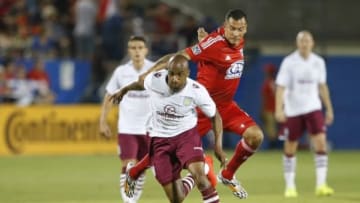 Jul 23, 2014; Frisco, TX, USA; Aston Villa midfielder Fabian Delph (16) runs for the ball as FC Dallas forward Blas Perez (7) defends during the second half at Toyota Stadium. Mandatory Credit: Kevin Jairaj-USA TODAY Sports