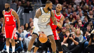 CLEVELAND, OH - FEBRUARY 3: LeBron James #23 of the Cleveland Cavaliers tries to drive around Chris Paul #3 of the Houston Rockets during the first half at Quicken Loans Arena on February 3, 2018 in Cleveland, Ohio. NOTE TO USER: User expressly acknowledges and agrees that, by downloading and or using this photograph, User is consenting to the terms and conditions of the Getty Images License Agreement. (Photo by Jason Miller/Getty Images)