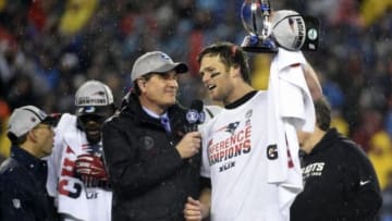 Jan 18, 2015; Foxborough, MA, USA; New England Patriots quarterback Tom Brady (right) holds up the Lamar Hunt Trophy after the AFC Championship Game against the Indianapolis Colts at Gillette Stadium. Mandatory Credit: Robert Deutsch-USA TODAY Sports