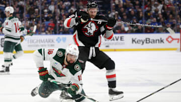 BUFFALO, NEW YORK - JANUARY 07: Jordan Greenway #18 of the Minnesota Wild skates against Zemgus Girgensons #28 of the Buffalo Sabres during the third period of an NHL hockey game at KeyBank Center on January 07, 2023 in Buffalo, New York. (Photo by Joshua Bessex/Getty Images)
