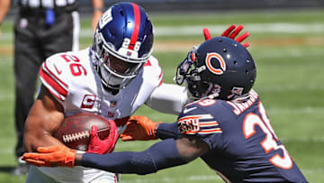 CHICAGO, ILLINOIS - SEPTEMBER 20: Saquon Barkley #26 of the New York Giants tries to fight off Eddie Jackson #39 of the Chicago Bears at Soldier Field on September 20, 2020 in Chicago, Illinois. (Photo by Jonathan Daniel/Getty Images)
