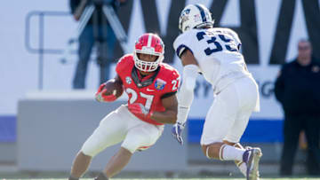 MEMPHIS, TN - DECEMBER 30: Running back Nick Chubb #27 of the Georgia Bulldogs looks to maneuver by linebacker Sammy Douglas #35 of the TCU Horned Frogs at Liberty Bowl Memorial Stadium on December 30, 2016 in Memphis, Tennessee. The Georgia Bulldogs defeated the TCU Horned Frogs 31-23. (Photo by Michael Chang/Getty Images)