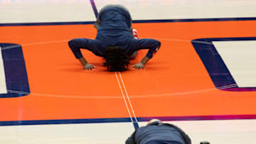 Feb 25, 2021; Champaign, Illinois, USA; Illinois Fighting Illini guard Ayo Dosunmu (11) kisses the floor during senior night prior to a game against the Nebraska Cornhuskers at the State Farm Center. Mandatory Credit: Patrick Gorski-USA TODAY Sports