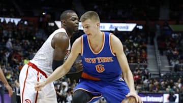 Jan 5, 2016; Atlanta, GA, USA; New York Knicks forward Kristaps Porzingis (6) drives against Atlanta Hawks forward Paul Millsap (4) in the first quarter of their game at Philips Arena. Mandatory Credit: Jason Getz-USA TODAY Sports