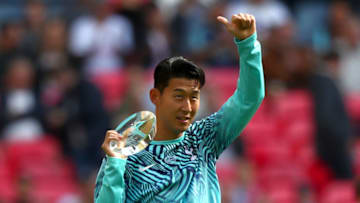 LONDON, ENGLAND - SEPTEMBER 15: Heung-Min Son of Tottenham Hotspur celebrates with the Asian Cup 2018 Trophy ahead of the Premier League match between Tottenham Hotspur and Liverpool FC at Wembley Stadium on September 15, 2018 in London, United Kingdom. (Photo by Clive Rose/Getty Images)