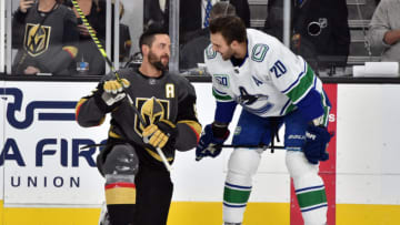 LAS VEGAS, NEVADA - DECEMBER 15: Deryk Engelland #5 of the Vegas Golden Knights and Brandon Sutter #20 of the Vancouver Canucks talk during warm-ups prior to their game at T-Mobile Arena on December 15, 2019 in Las Vegas, Nevada. (Photo by David Becker/NHLI via Getty Images)