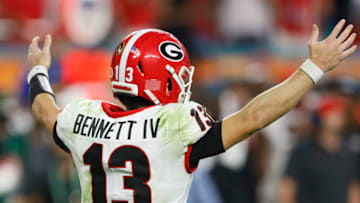 MIAMI GARDENS, FLORIDA - DECEMBER 31: Stetson Bennett #13 of the Georgia Bulldogs reacts in the fourth quarter of the game against the Michigan Wolverines in the Capital One Orange Bowl for the College Football Playoff semifinal game at Hard Rock Stadium on December 31, 2021 in Miami Gardens, Florida. (Photo by Michael Reaves/Getty Images)