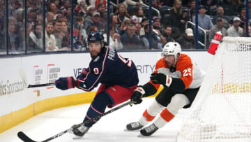 COLUMBUS, OHIO - OCTOBER 12: Ivan Provorov #9 of the Columbus Blue Jackets and Ryan Poehling #25 of the Philadelphia Flyers battle for the puck behind the net during the first period at Nationwide Arena on October 12, 2023 in Columbus, Ohio. (Photo by Jason Mowry/Getty Images)