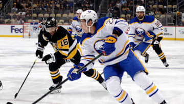 Oct 7, 2022; Pittsburgh, Pennsylvania, USA; Buffalo Sabres right wing Jack Quinn (22) skates with the puck ahead of Pittsburgh Penguins left wing Jason Zucker (16) during the first period at PPG Paints Arena. Mandatory Credit: Charles LeClaire-USA TODAY Sports