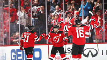 NEWARK, NEW JERSEY - DECEMBER 21: Kyle Palmieri #21 of the New Jersey Devils (l) celebrates his first period goal against the Ottawa Senators along with Taylor Hall #9 (c) and Steven Santini #16 at the Prudential Center on December 21, 2018 in Newark, New Jersey. (Photo by Bruce Bennett/Getty Images)