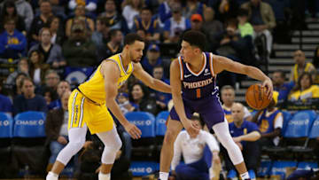 OAKLAND, CA - MARCH 10: Devin Booker #1 of the Phoenix Suns is guarded by Stephen Curry #30 of the Golden State Warriors at ORACLE Arena on March 10, 2019 in Oakland, California. NOTE TO USER: User expressly acknowledges and agrees that, by downloading and or using this photograph, User is consenting to the terms and conditions of the Getty Images License Agreement. (Photo by Lachlan Cunningham/Getty Images)