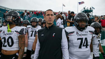 University of Cincinnati Bearcats head coach Luke Fickell and his team take the field to face Tulane. The Enquirer.
