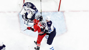 RALEIGH, NC - MARCH 04: Carolina Hurricanes Left Wing Jeff Skinner (53) attempts to redirect a puck in front of Winnipeg Jets Goalie Connor Hellebuyck (37) while being defended by Winnipeg Jets Defenceman Tyler Myers (57) during a game between the Winnipeg Jets and the Carolina Hurricanes at the PNC Arena in Raleigh, NC on March 4, 2018. Winnipeg defeated Carolina 3-2. (Photo by Greg Thompson/Icon Sportswire via Getty Images)