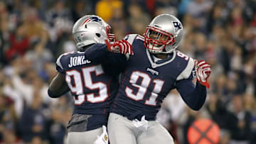 Oct 29, 2015; Foxborough, MA, USA; New England Patriots linebacker Jamie Collins (91) celebrates a sack by defensive end Chandler Jones (95) on Miami Dolphins quarterback Ryan Tannehill during the second quarter at Gillette Stadium. Mandatory Credit: Stew Milne-USA TODAY Sports