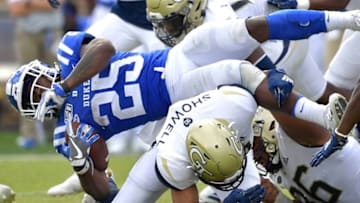 DURHAM, NORTH CAROLINA - OCTOBER 12: Avery Showell #13 of the Georgia Tech Yellow Jackets upends Deon Jackson #25 of the Duke Blue Devils during the second half of their game at Wallace Wade Stadium on October 12, 2019 in Durham, North Carolina. Duke won 41-23. (Photo by Grant Halverson/Getty Images)