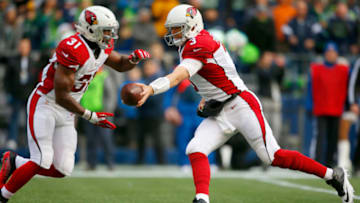 SEATTLE, WA - DECEMBER 24: Quarterback Carson Palmer #3 of the Arizona Cardinals hands off to running back David Johnson #31 against the Seattle Seahawks at CenturyLink Field on December 24, 2016 in Seattle,Washington. (Photo by Otto Greule Jr/Getty Images)