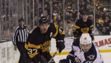 Nov 19, 2016; Boston, MA, USA; Boston Bruins center Patrice Bergeron (37) and Winnipeg Jets center Nic Petan (19) chase the puck during the first period at TD Garden. Mandatory Credit: Gregory J. Fisher-USA TODAY Sports