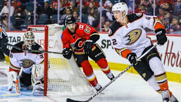 Dec 29, 2016; Calgary, Alberta, CAN; Anaheim Ducks defenseman Josh Manson (42) controls the puck in front of Calgary Flames right wing Michael Frolik (67) during the third period at Scotiabank Saddledome. Anaheim Ducks won 3-1. Mandatory Credit: Sergei Belski-USA TODAY Sports
