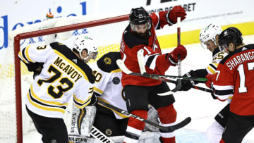 NEWARK, NEW JERSEY - JANUARY 14: Tuukka Rask #40 of the Boston Bruins is unable to stop a shot by Ty Smith #24 of the New Jersey Devils as Kyle Palmieri #21 of the Devils block in front in the third period during the home opening game at Prudential Center on January 14, 2021 in Newark, New Jersey. (Photo by Elsa/Getty Images)