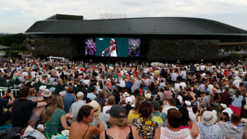 Spectators on Murray Mount (Henman Hill) watch a big screen showing US player Cori Gauff playing against Slovenia's Polona Hercog during their women's singles third round match on the fifth day of the 2019 Wimbledon Championships at The All England Lawn Tennis Club in Wimbledon, southwest London, on July 5, 2019. (Photo by Adrian DENNIS / AFP) / RESTRICTED TO EDITORIAL USE (Photo credit should read ADRIAN DENNIS/AFP via Getty Images)