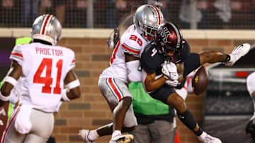 Sep 2, 2021; Minneapolis, Minnesota, USA; Ohio State Buckeyes cornerback Denzel Burke (29) breaks up a pass intended for Minnesota Gophers running back Mar'Keise Irving (4) during the second quarter at Huntington Bank Stadium. Mandatory Credit: Harrison Barden-USA TODAY Sports