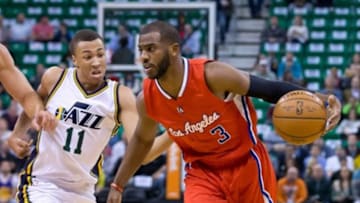 Jan 28, 2015; Salt Lake City, UT, USA; Los Angeles Clippers guard Chris Paul (3) dribbles the ball as Utah Jazz guard Dante Exum (11) defends during the first quarter at EnergySolutions Arena. Mandatory Credit: Russ Isabella-USA TODAY Sports