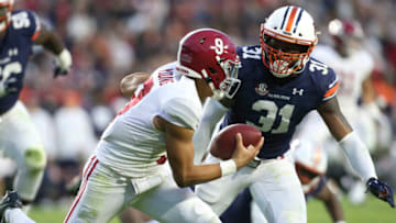 Auburn footballNov 27, 2021; Auburn, Alabama, USA; Auburn Tigers linebacker Chandler Wooten (31) tackles Alabama Crimson Tide quarterback Bryce Young (9) at Jordan-Hare Stadium. Alabama defeated Auburn in four overtimes. Mandatory Credit: Gary Cosby Jr.-USA TODAY Sports