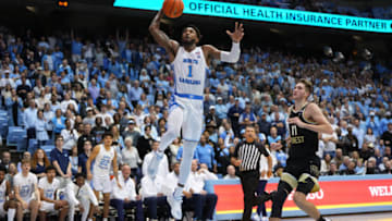 Jan 4, 2023; Chapel Hill, North Carolina, USA; North Carolina Tar Heels forward Leaky Black (1) scores as Wake Forest Demon Deacons forward Andrew Carr (11) defends in the second half at Dean E. Smith Center. Mandatory Credit: Bob Donnan-USA TODAY Sports