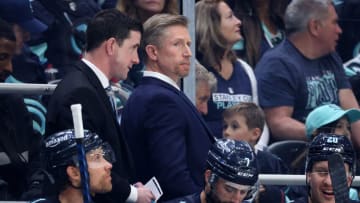 SEATTLE, WASHINGTON - APRIL 28: Assistant coach Paul McFarland and head coach Dave Hakstol of the Seattle Kraken talk against the Colorado Avalanche during the second period in Game Six of the First Round of the 2023 Stanley Cup Playoffs at Climate Pledge Arena on April 28, 2023 in Seattle, Washington. (Photo by Steph Chambers/Getty Images)