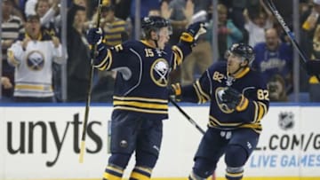 Oct 8, 2015; Buffalo, NY, USA; Buffalo Sabres center Jack Eichel (15) celebrates with left wing Marcus Foligno (82) after scoring his first NHL goal during the third period against the Ottawa Senators at First Niagara Center. Mandatory Credit: Kevin Hoffman-USA TODAY Sports