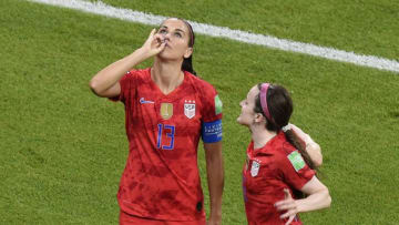 United States' forward Alex Morgan (L) is congratulated by teammates after scoring a goal during the France 2019 Women's World Cup semi-final football match between England and USA, on July 2, 2019, at the Lyon Satdium in Decines-Charpieu, central-eastern France. (Photo by Jean-Philippe KSIAZEK / AFP) (Photo credit should read JEAN-PHILIPPE KSIAZEK/AFP/Getty Images)
