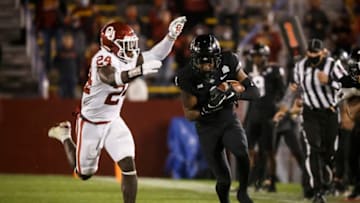 Oct 3, 2020; Ames, Iowa, USA; Oklahoma linebacker Brian Asamoah (24) tackles Iowa State wide receiver Tarique Milton (1) during their football game at Jack Trice Stadium. Oklahoma takes a 17-13 lead over ISU into halftime. Mandatory Credit: Brian Powers-USA TODAY Sports