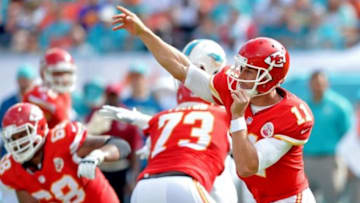 Sep 21, 2014; Miami Gardens, FL, USA; Kansas City Chiefs quarterback Alex Smith (11) throws a pass against the Miami Dolphins defense during the first half at Sun Life Stadium. Mandatory Credit: Steve Mitchell-USA TODAY Sports